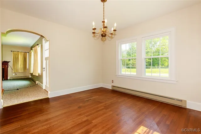 a view of a livingroom with wooden floor and a ceiling fan