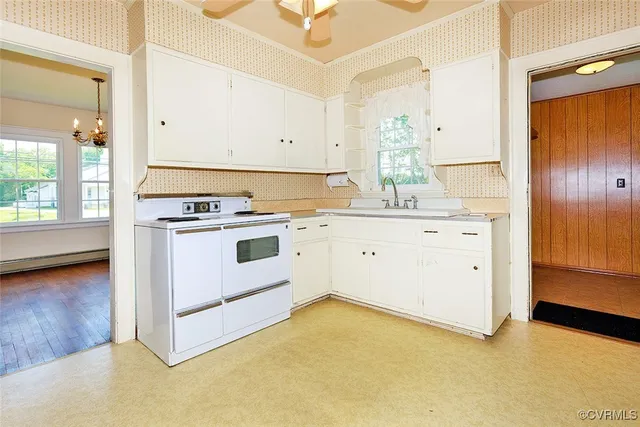 a kitchen with a stove a sink and a refrigerator