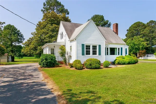 a view of a house with a big yard and potted plants