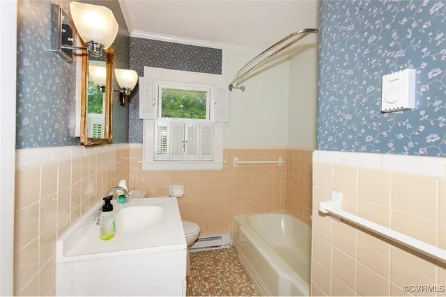 a bathroom with a sink a bathtub and a window