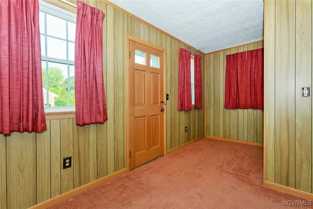 a view of a bedroom with a bed and a window