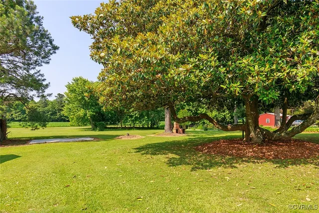 a view of a house with swimming pool and yard
