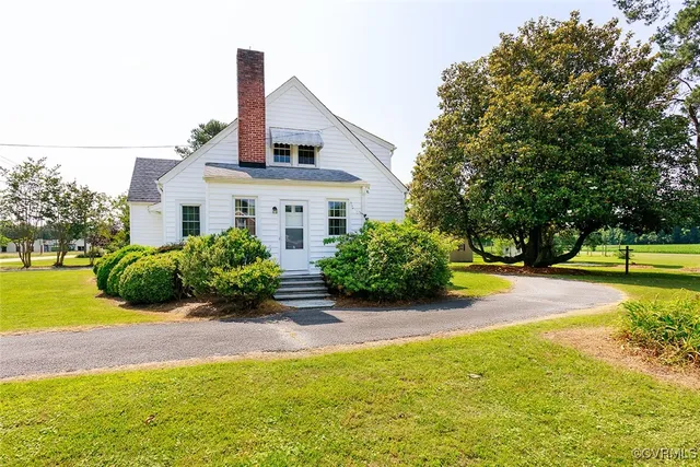a view of a house with swimming pool and sitting area