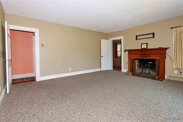 a view of an empty room with a fireplace