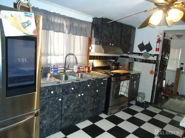 a kitchen with a sink a stove and cabinets
