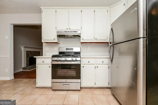 a kitchen with cabinets and a stove top oven