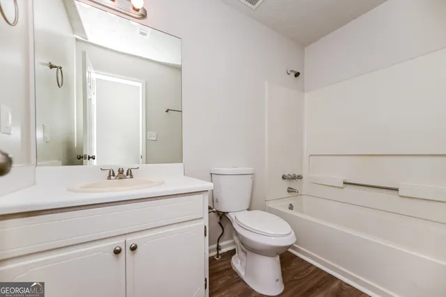 a bathroom with a sink a toilet and a bathtub