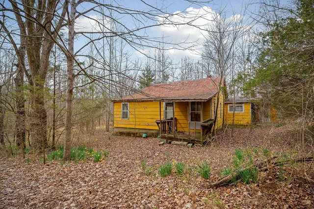 a front view of a house with yard and seating area