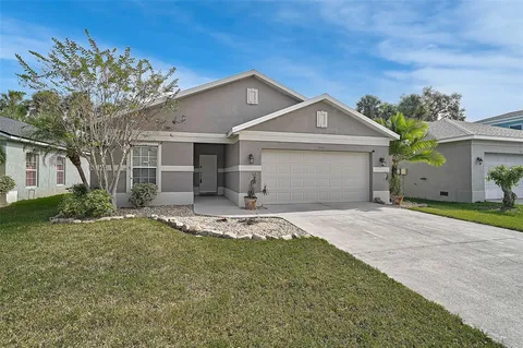 a front view of a house with a yard and garage