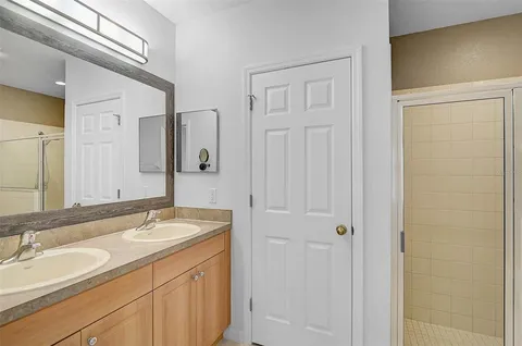 a bathroom with 2 sink and a mirror