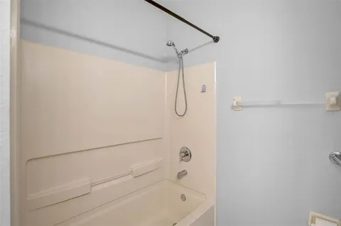 a bathroom with a shower and a shower