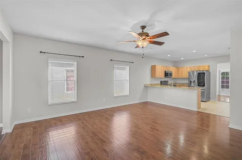 a view of a kitchen with wooden floor and a kitchen