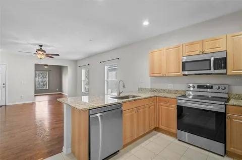 a kitchen with stainless steel appliances granite countertop a sink and stove top oven