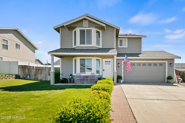 a front view of house with yard and garage