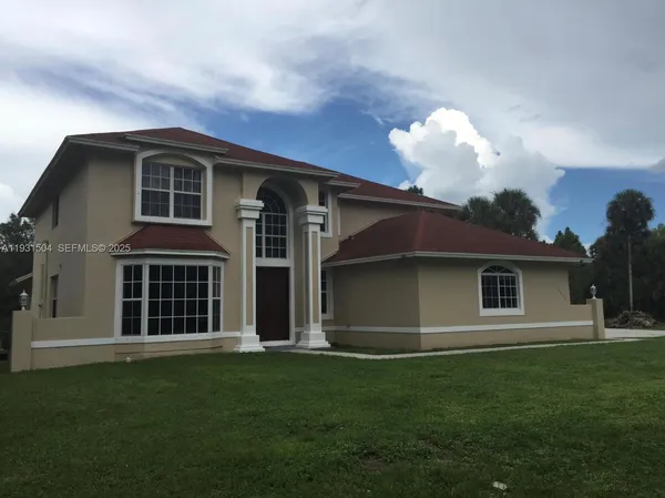 a front view of a house with a garden