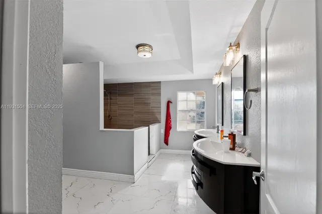 a bathroom with a sink a mirror and a bathtub