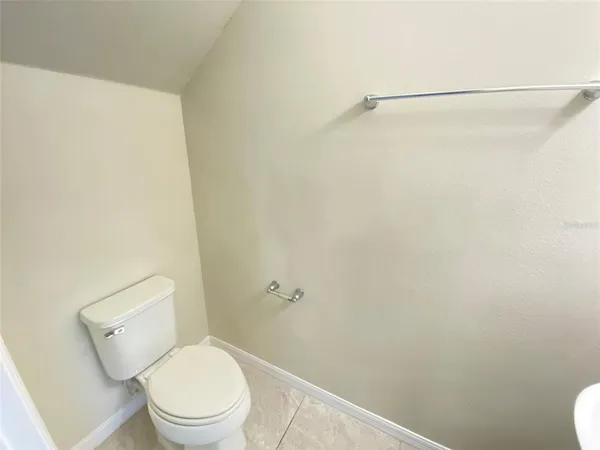 a white toilet sitting next to a shower
