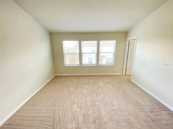 an empty room with a empty space and windows
