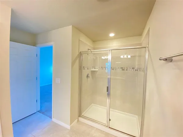 a bathroom with a shower and a glass door