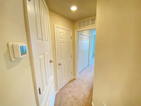 a view of a hallway with wooden shelves