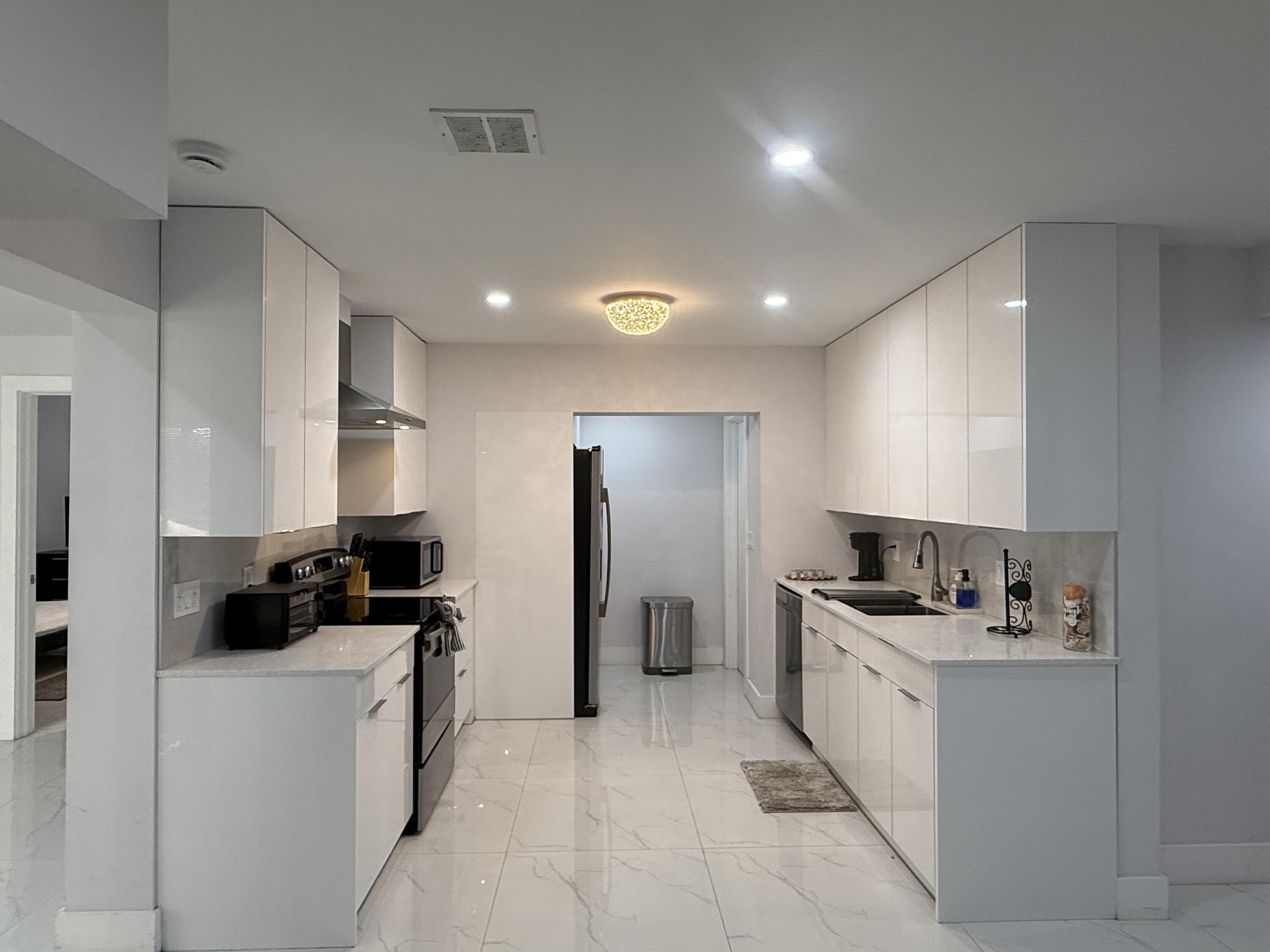 255 Glouchester Street Boca Raton, FL 33487 - Photo 5 of 11 a kitchen with refrigerator and cabinets