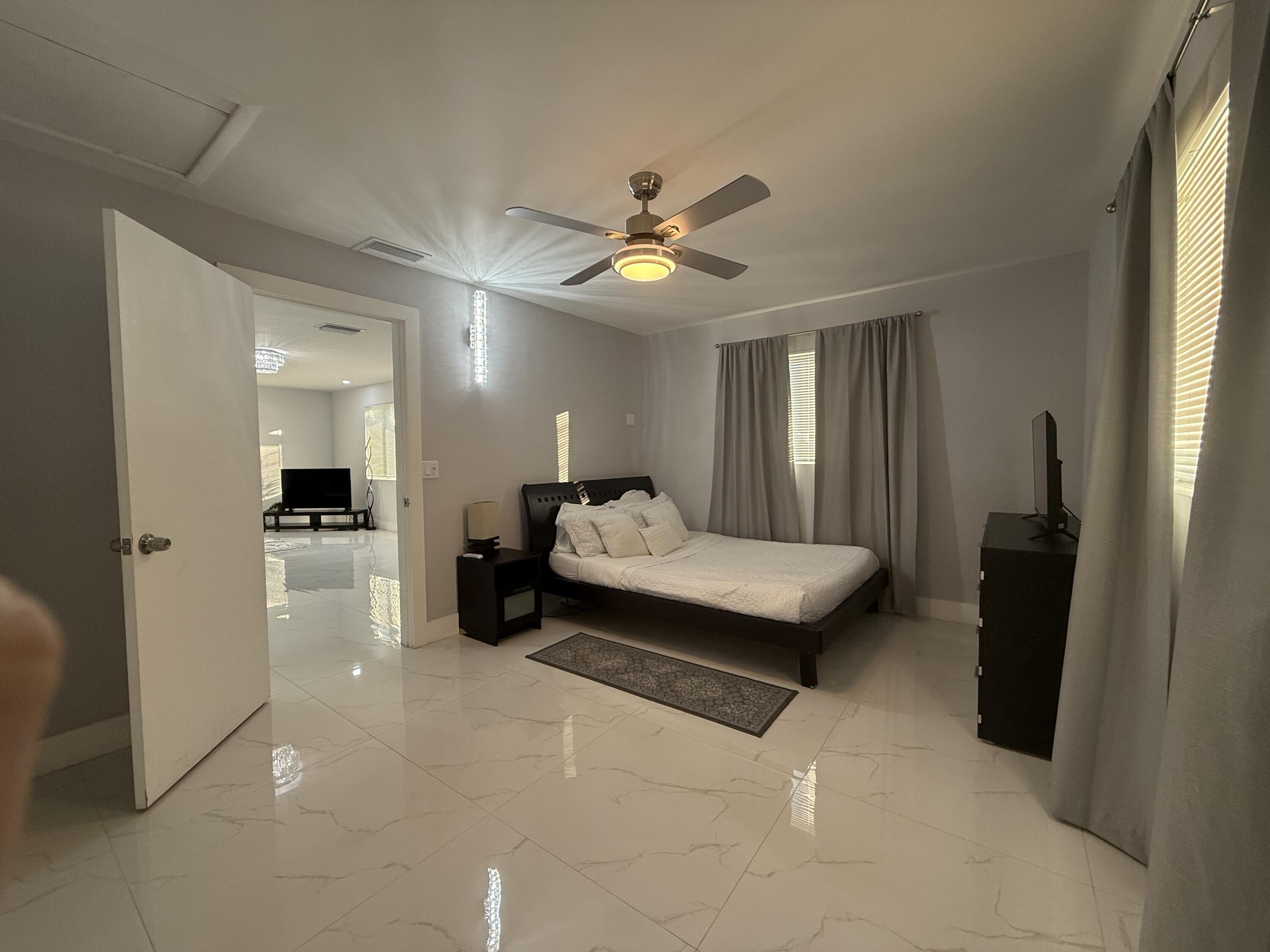 255 Glouchester Street Boca Raton, FL 33487 - Photo 6 of 11 a living room with furniture and a chandelier