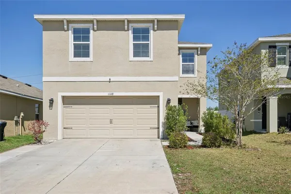 a front view of a house with a yard and garage