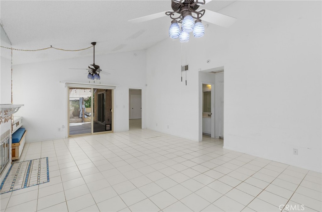 29368 Murrieta Road Menifee, CA 92586 - Photo 7 of 20 an empty room with chandelier fan and windows