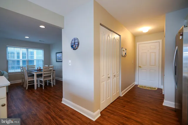 a view of a dining room and livingroom with furniture wooden floor a chandelier