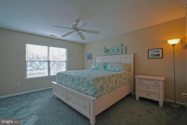 a spacious bedroom with a bed and a window