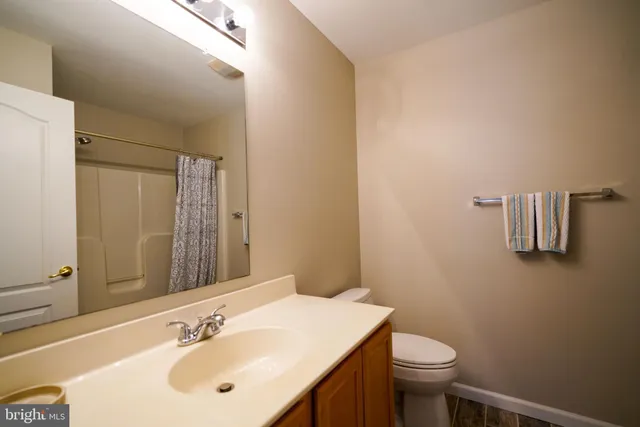 a bathroom with a sink toilet and mirror