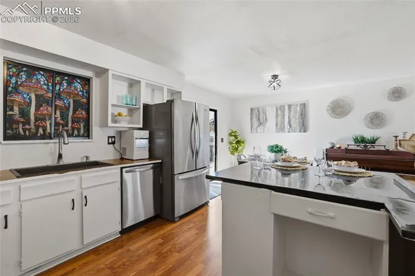 a kitchen with a refrigerator and a sink