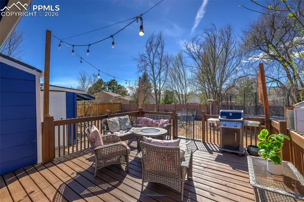a view of a patio with couches table and chairs and potted plants