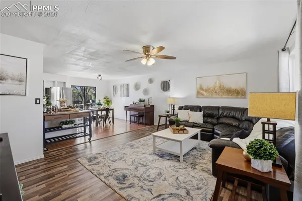 a living room with furniture and wooden floor