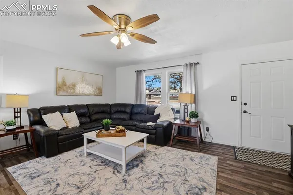 a living room with furniture and wooden floor
