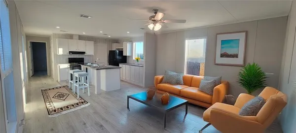 a living room with furniture kitchen and a table