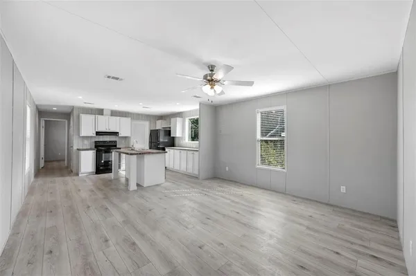 a view of kitchen with granite countertop cabinets and refrigerator