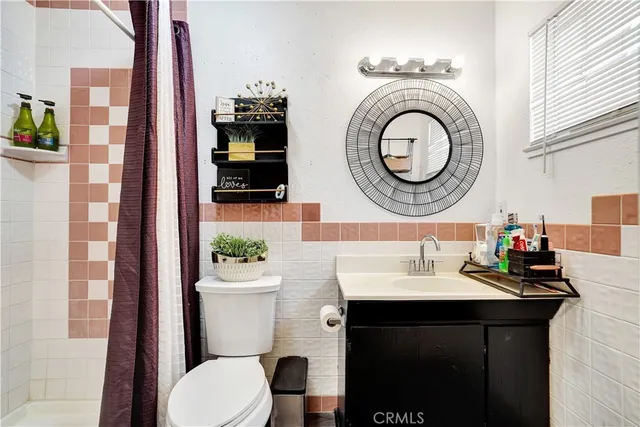 a bathroom with a sink a mirror and a toilet