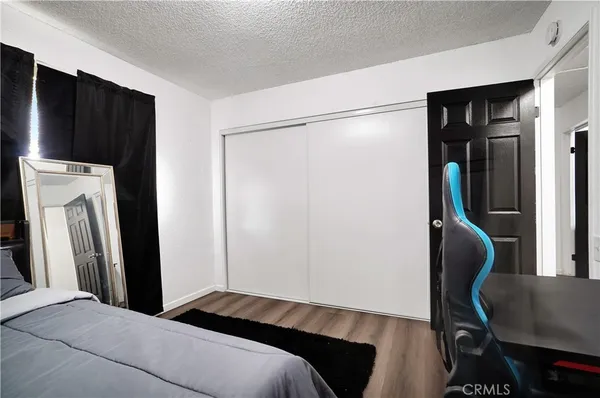 a bedroom with a bed and a chair