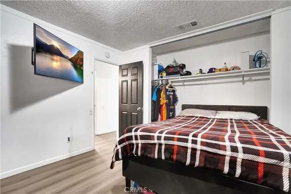 a bedroom with a bed and dresser