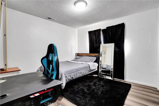 a bed room with a bed and a desk