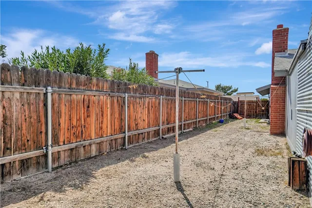 a view of a backyard with wooden fence