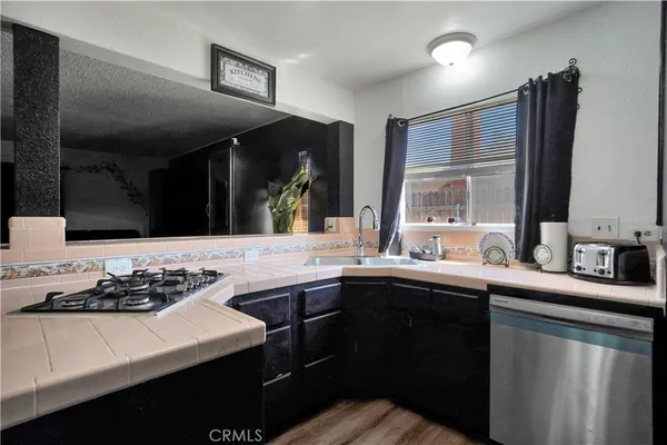 a kitchen with a sink stove and cabinets