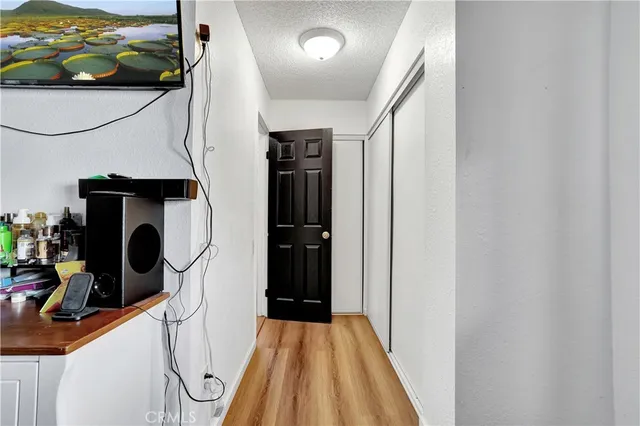 a view of a hallway with wooden floor