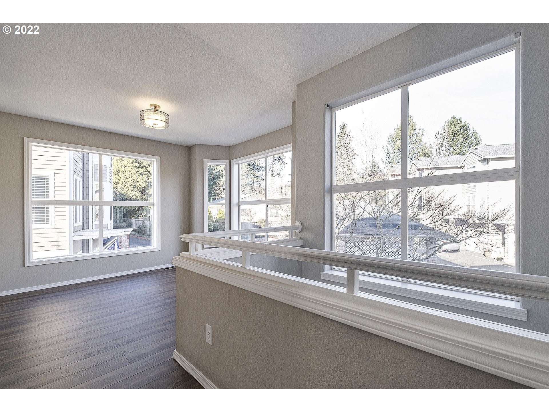 15718 Southwest Flagstone Drive Beaverton, OR 97007 - Photo 11 of 32 a view of empty room with wooden floor and fan