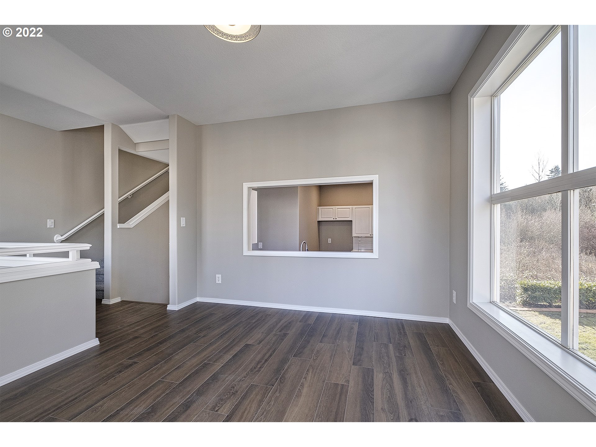 15718 Southwest Flagstone Drive Beaverton, OR 97007 - Photo 13 of 32 a view of an empty room with wooden floor and a window
