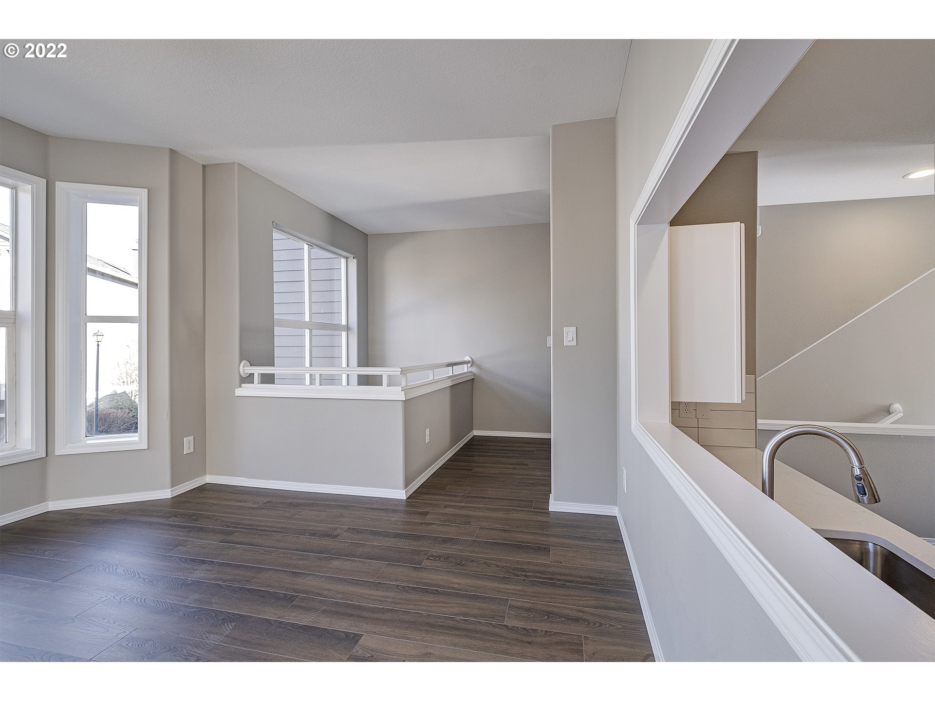 15718 Southwest Flagstone Drive Beaverton, OR 97007 - Photo 14 of 32 a view of an empty room with wooden floor and a window
