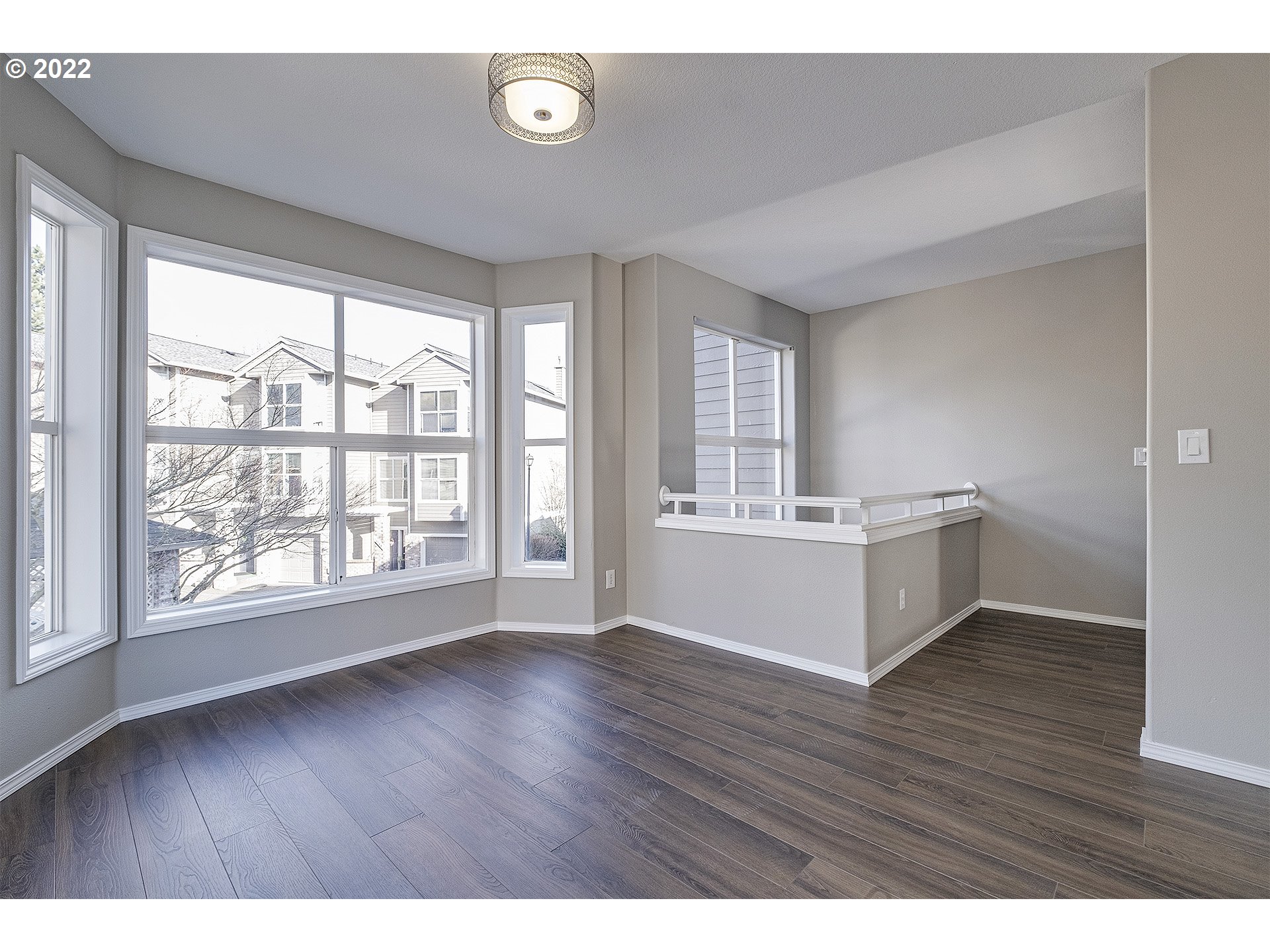 15718 Southwest Flagstone Drive Beaverton, OR 97007 - Photo 15 of 32 a view of an empty room with wooden floor and a window