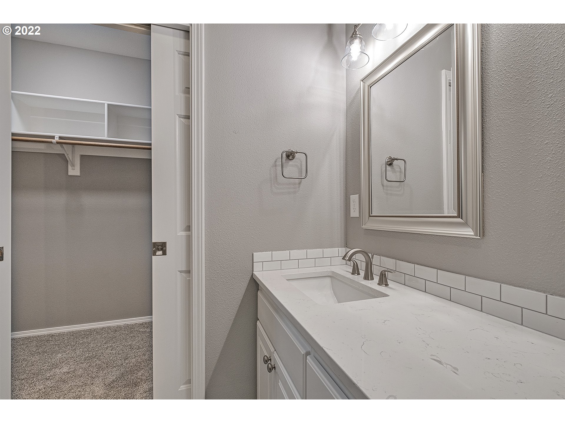 15718 Southwest Flagstone Drive Beaverton, OR 97007 - Photo 25 of 32 a bathroom with a sink vanity granite and a mirror