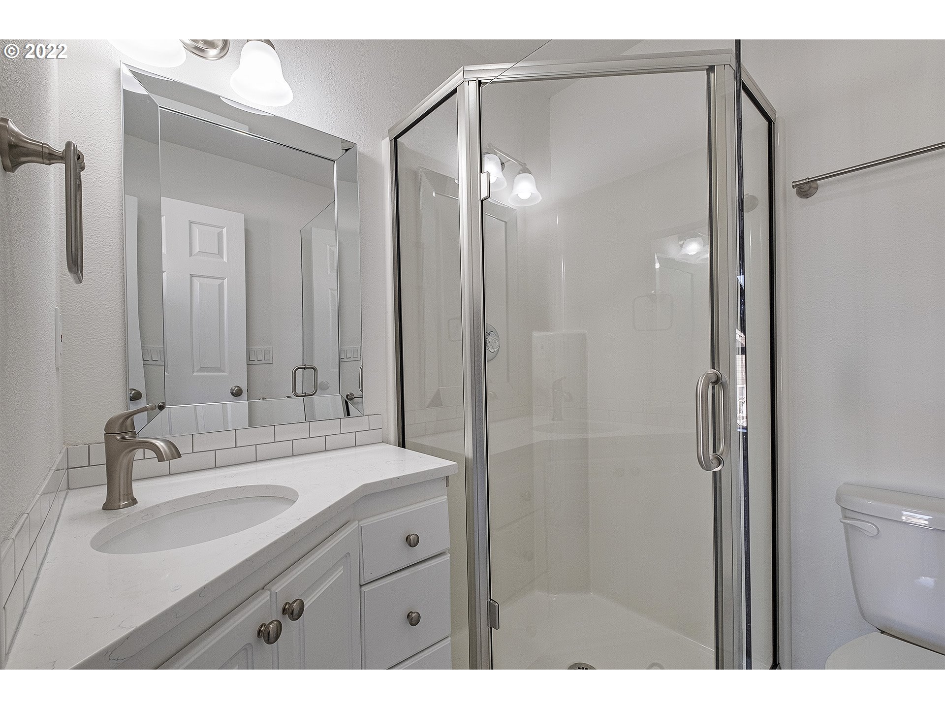 15718 Southwest Flagstone Drive Beaverton, OR 97007 - Photo 28 of 32 a bathroom with a shower sink vanity mirror and toilet